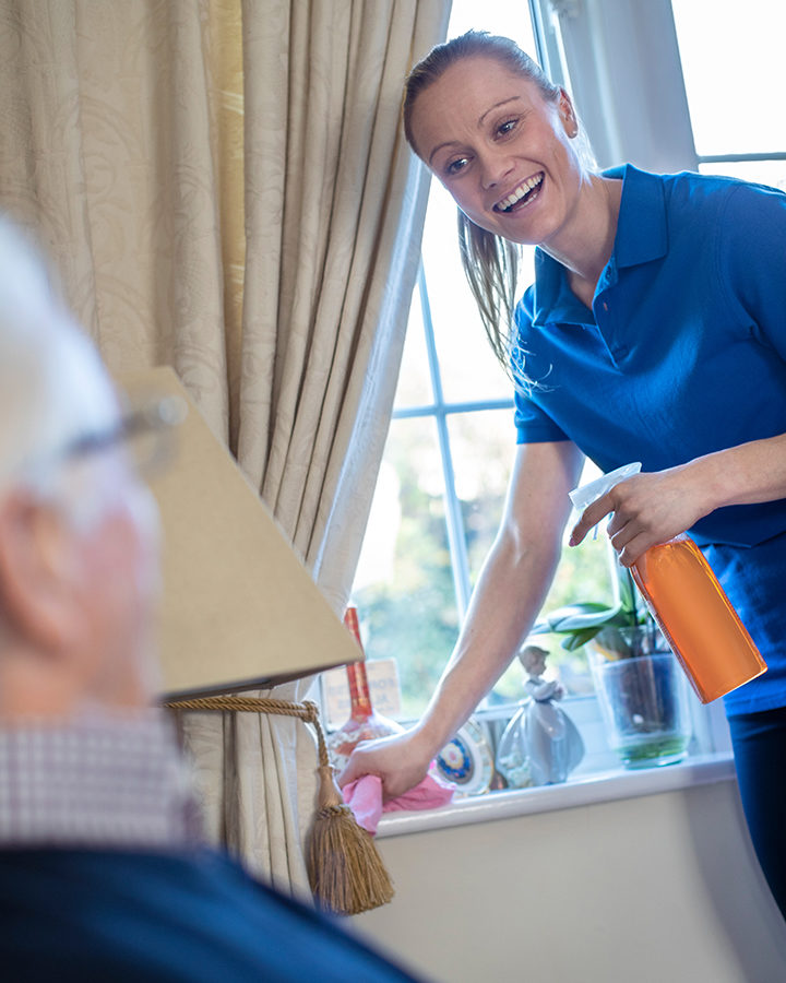 Employee smiling while cleaning